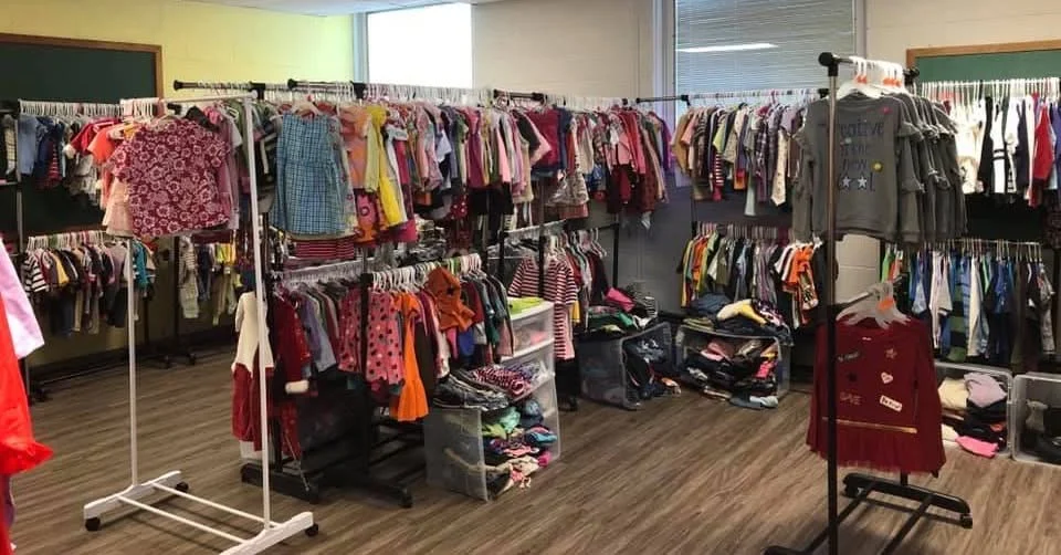 The closet set up for a Saturday, racks packed with children's clothing