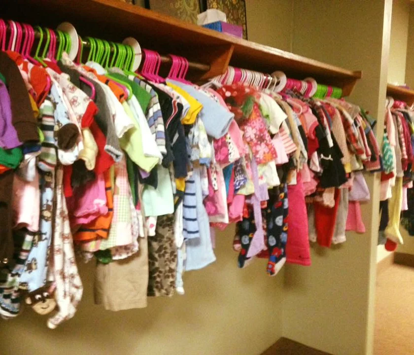 A rack of small children's clothes on hangers